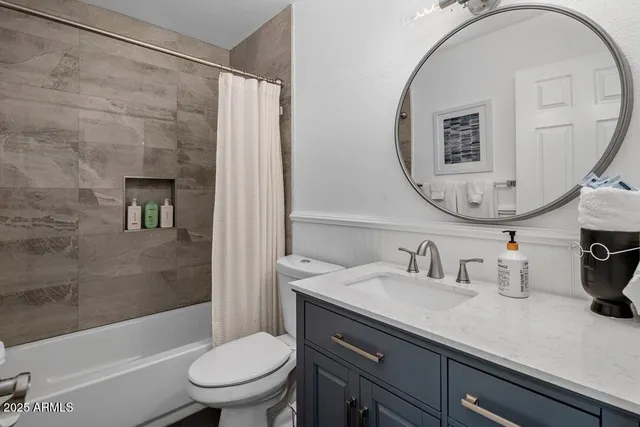 a bathroom with a sink a toilet and a mirror