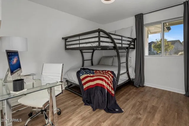 a bedroom with a bed and a window