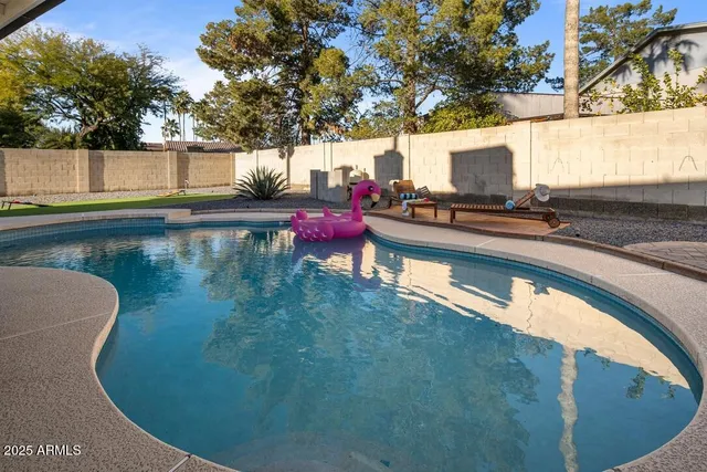 a view of swimming pool with a patio