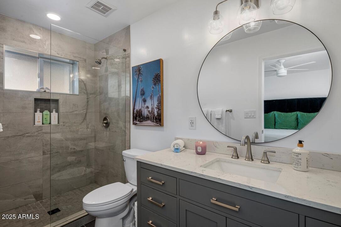 4526 East Paradise Lane Phoenix, AZ 85032 - Photo 4 of 48 a bathroom with a granite countertop sink mirror toilet and shower