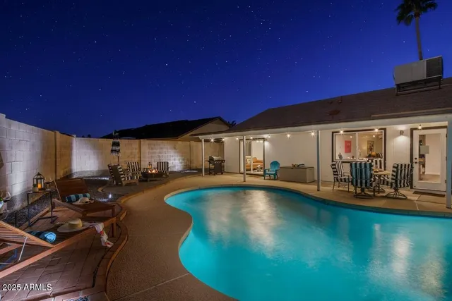 a view of a swimming pool with outdoor seating