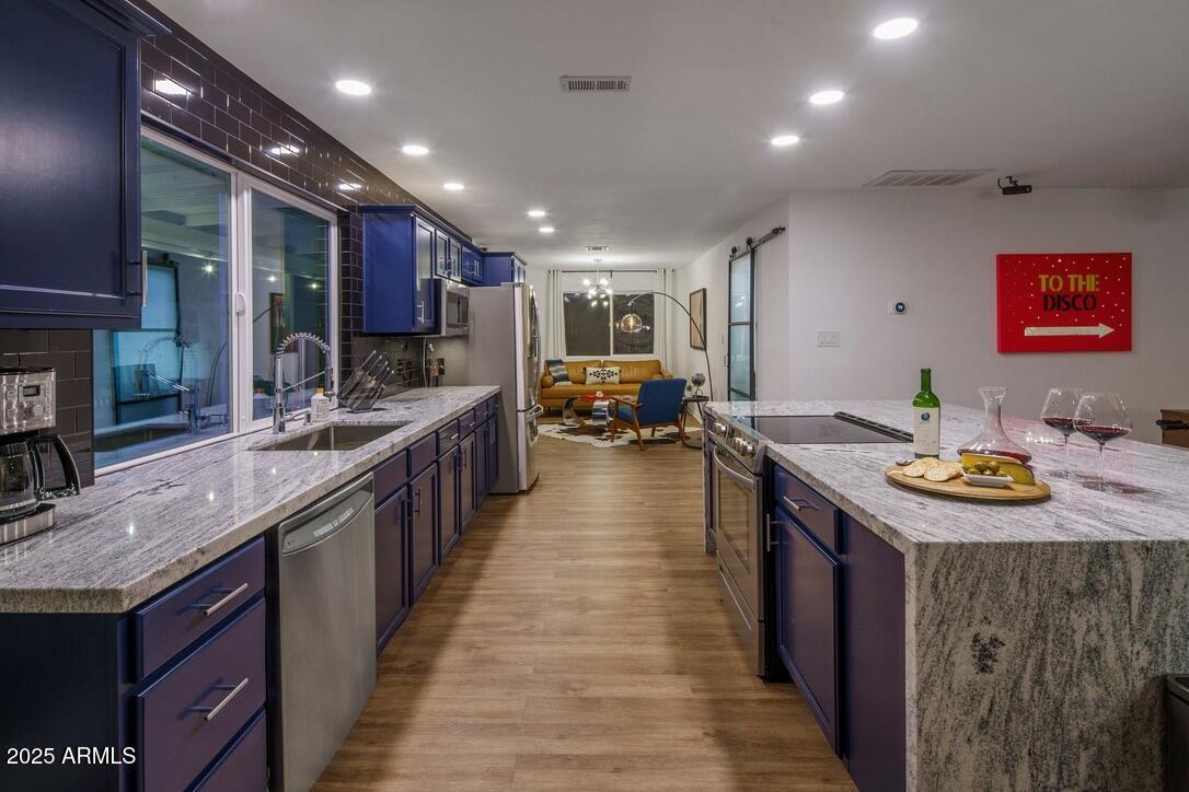 4526 East Paradise Lane Phoenix, AZ 85032 - Photo 9 of 48 a kitchen with stainless steel appliances granite countertop a sink stove and refrigerator