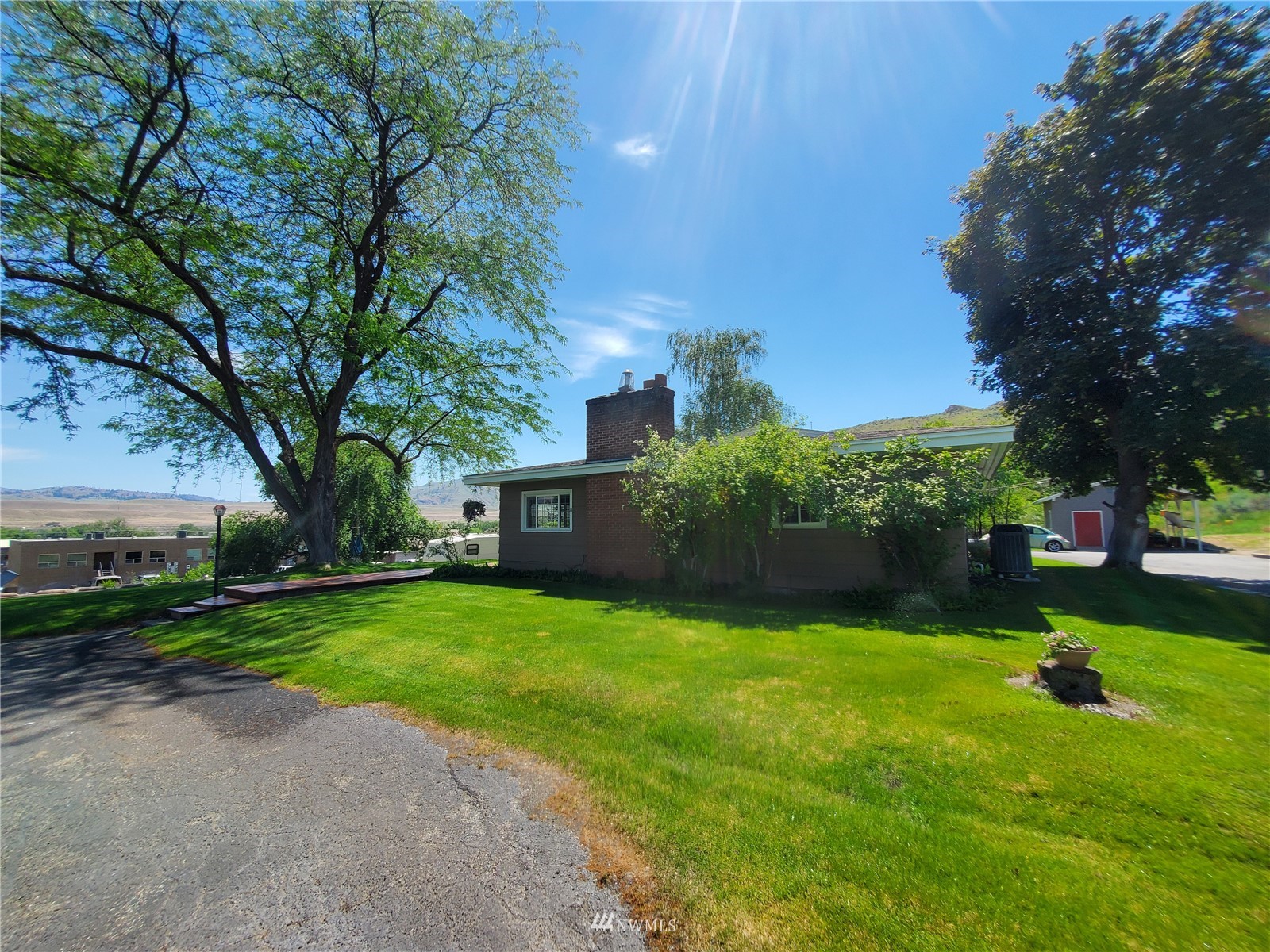 11 Haussler Road Omak, WA 98841 - Photo 4 of 40 a front view of a house with garden and trees