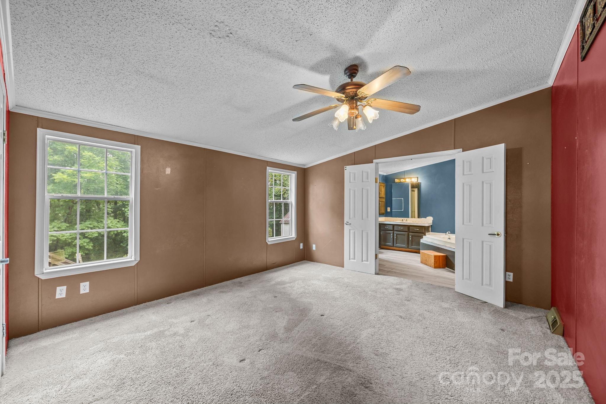 573 Deep Gap Loop Road Flat Rock, NC 28731 - Photo 12 of 20 an empty room with windows and ceiling fan