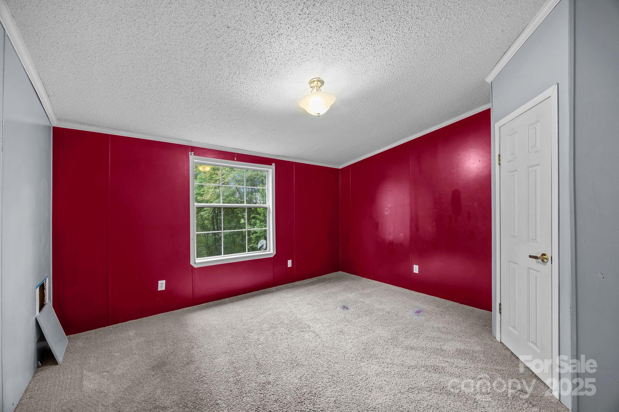 573 Deep Gap Loop Road Flat Rock, NC 28731 - Photo 15 of 20 a view of a livingroom with a red chair and window
