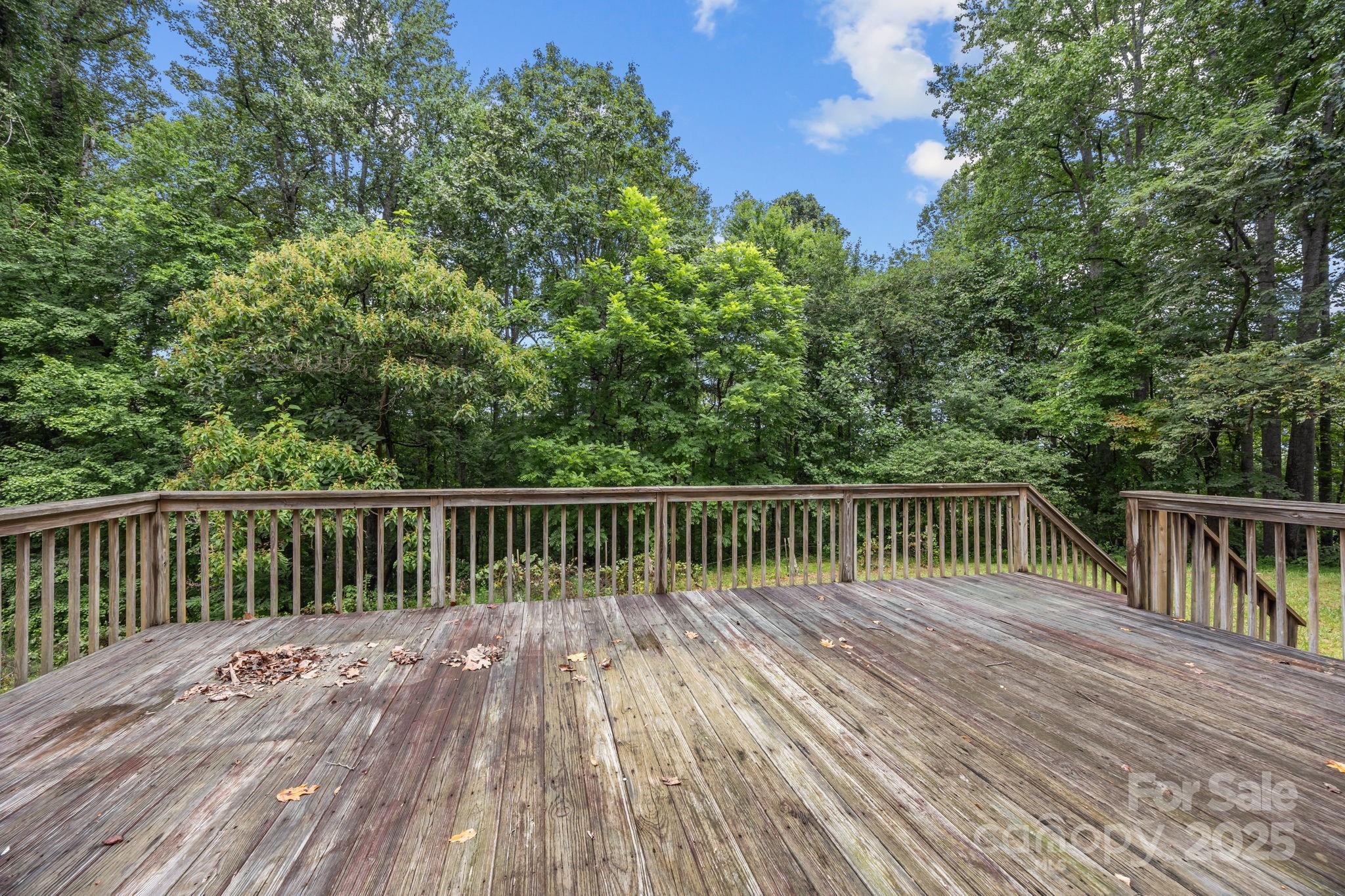 573 Deep Gap Loop Road Flat Rock, NC 28731 - Photo 16 of 20 a balcony with wooden floor and trees