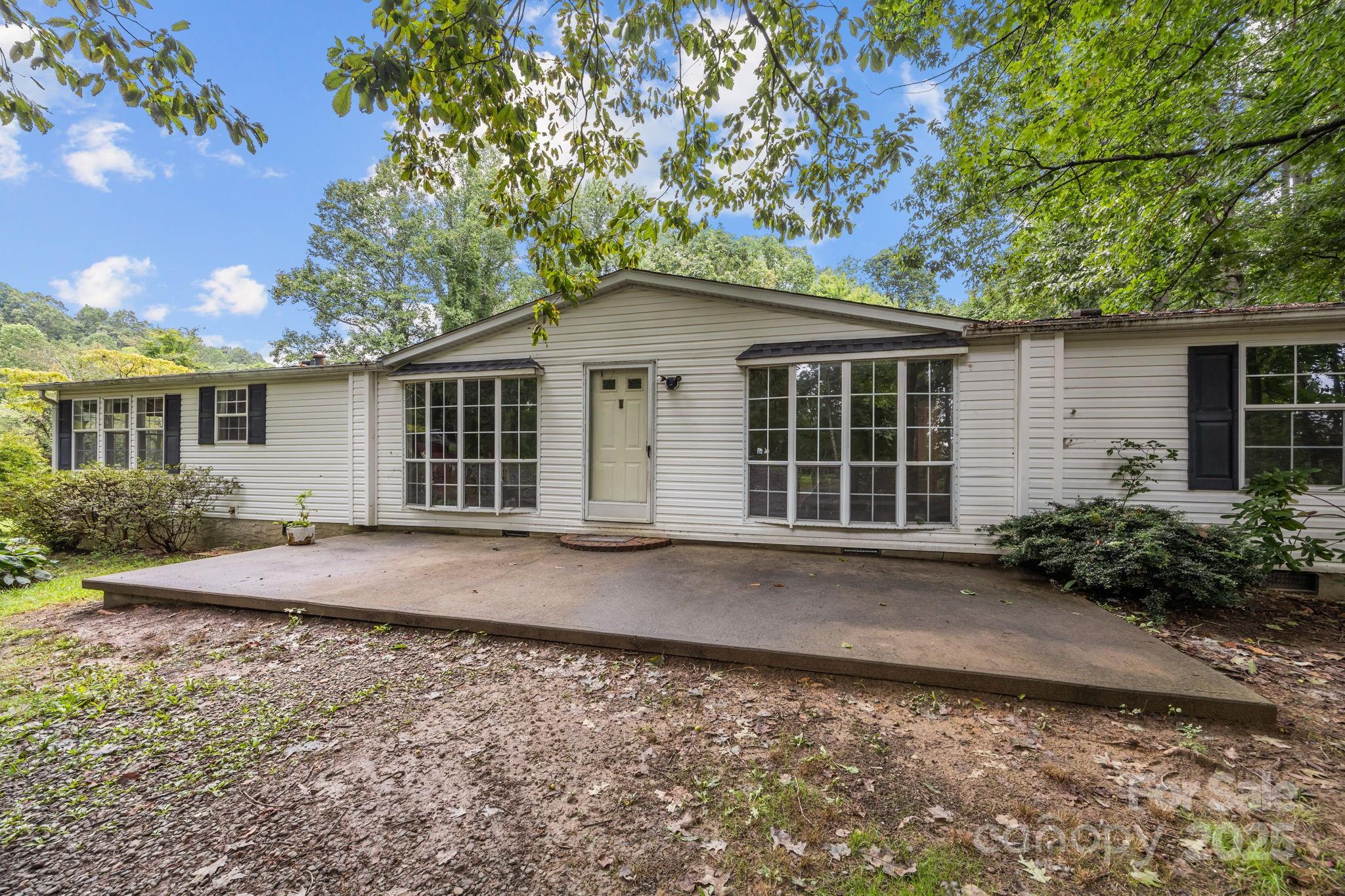 573 Deep Gap Loop Road Flat Rock, NC 28731 - Photo 17 of 20 front view of a house with a yard