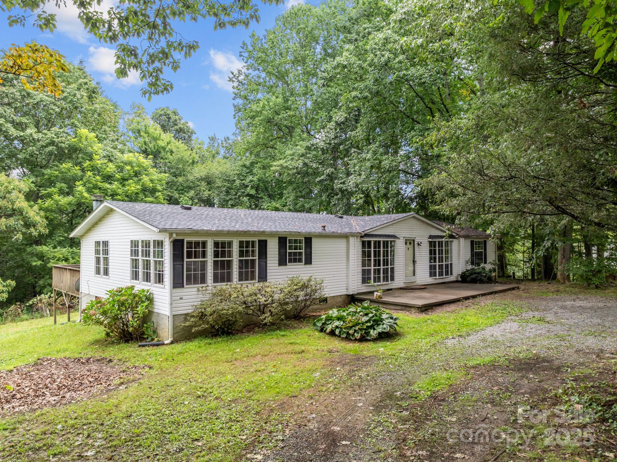 573 Deep Gap Loop Road Flat Rock, NC 28731 - Photo 3 of 20 a front view of a house with a garden