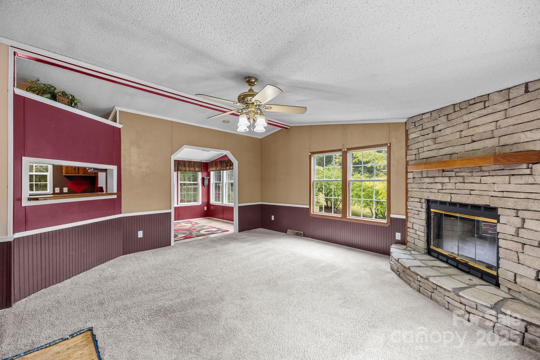 573 Deep Gap Loop Road Flat Rock, NC 28731 - Photo 5 of 20 a view of livingroom with fireplace fan and windows