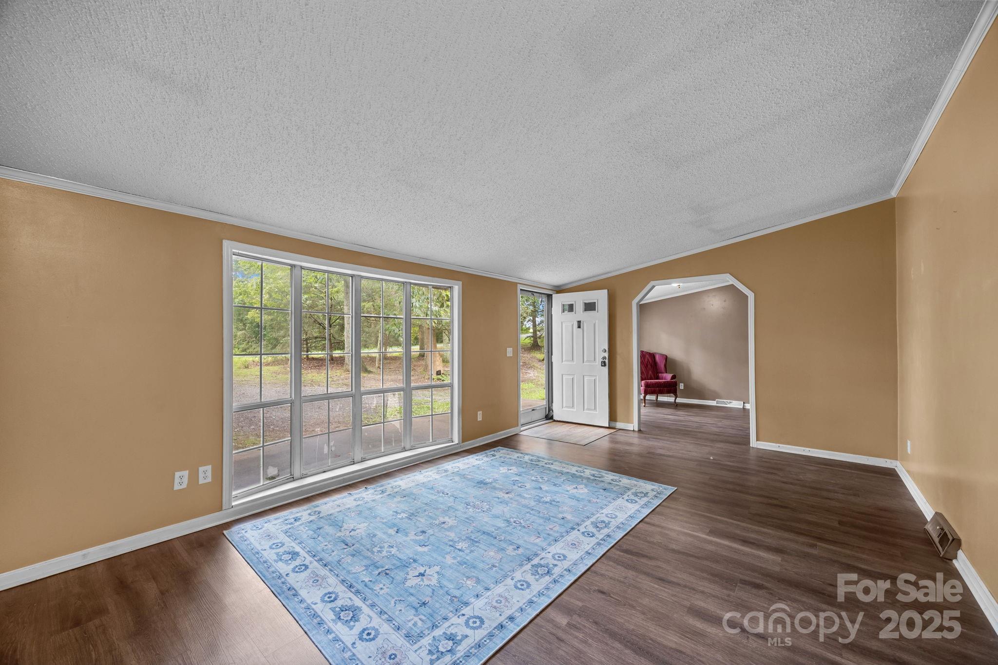 573 Deep Gap Loop Road Flat Rock, NC 28731 - Photo 6 of 20 an empty room with wooden floor and windows