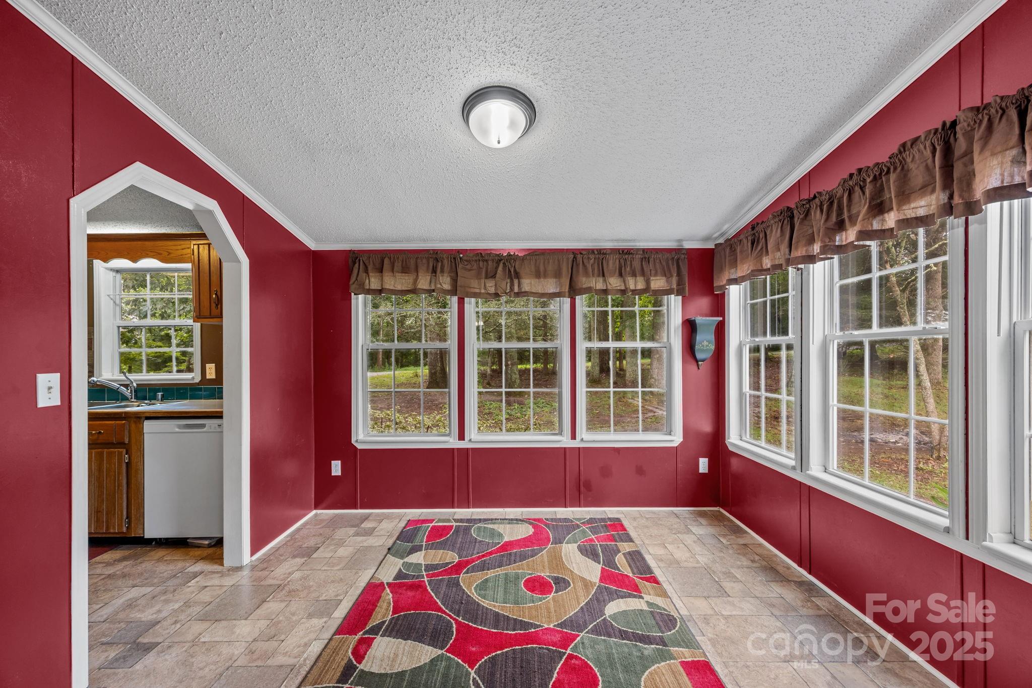 573 Deep Gap Loop Road Flat Rock, NC 28731 - Photo 10 of 20 a view of a bedroom with a bed and a window