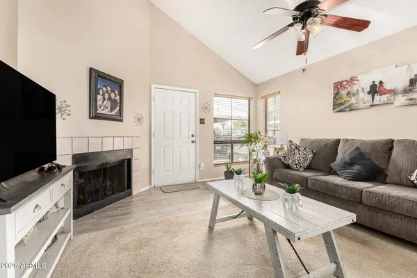 a living room with furniture a fireplace and a flat screen tv