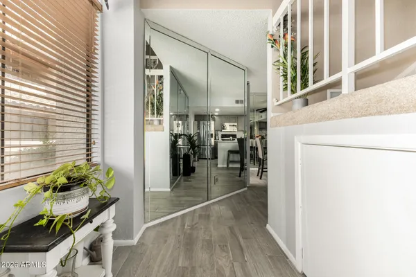 a hallway with a dining table a chandelier and a dining table