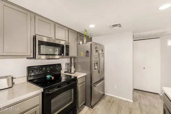 a kitchen with a refrigerator stove and microwave
