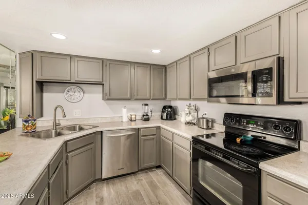 a kitchen with a sink cabinets and stainless steel appliances