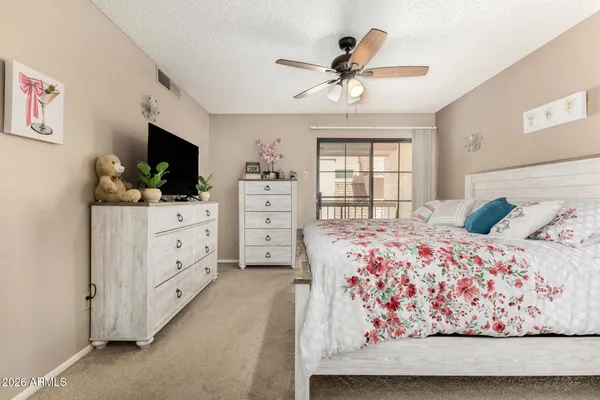 a bedroom with a bed and a flat screen tv in it