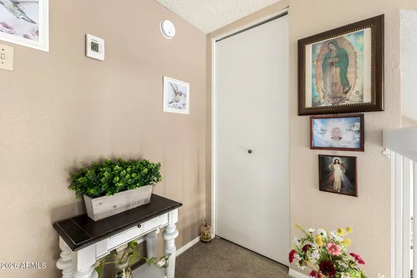 a room with painting on the wall and a potted plant
