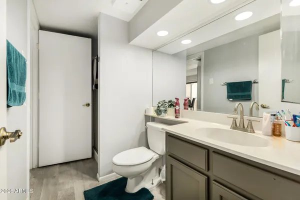 a bathroom with a sink toilet and mirror