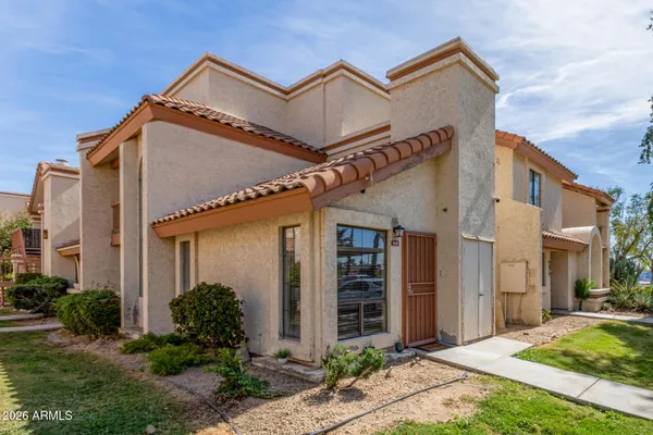a view of a house with a small yard and floor to ceiling window