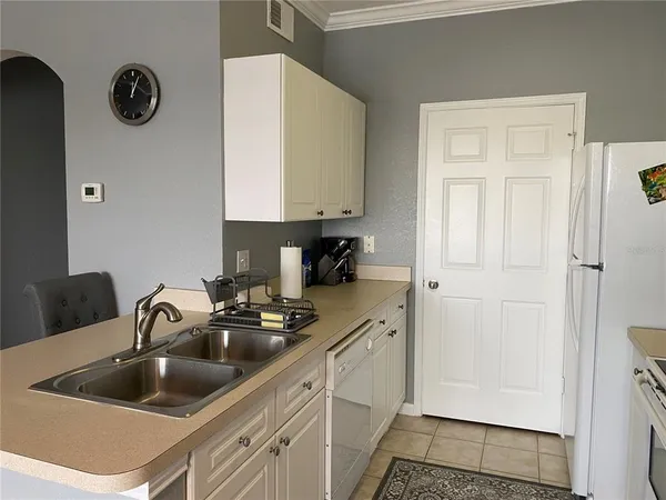 a kitchen with a sink cabinets and a refrigerator