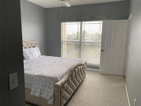 a bed sitting in a bedroom next to a window