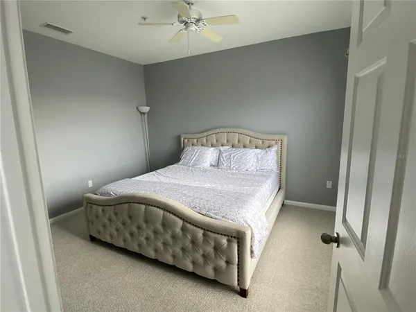 a bedroom with a bed and a chandelier