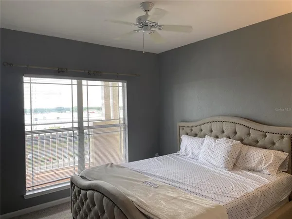 a bedroom with a large bed and a window