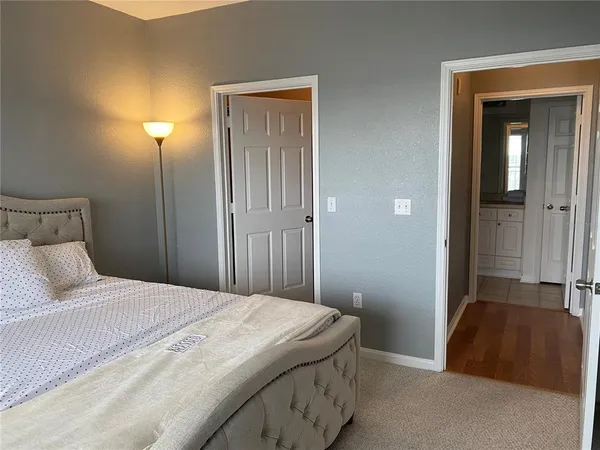 a bedroom with a bed and a night stand