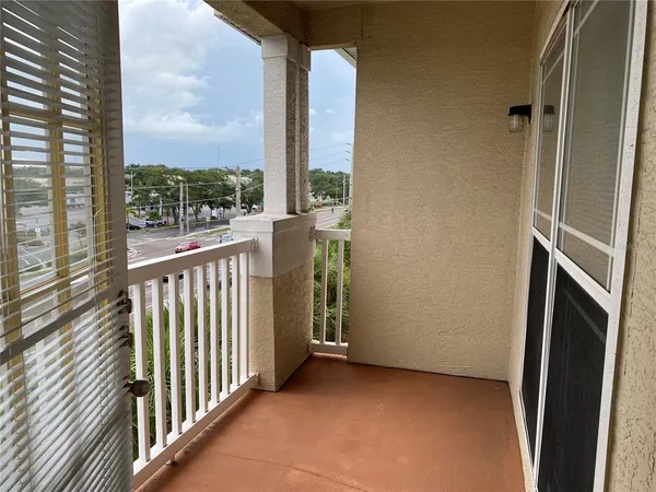 a view of a porch with wooden floor and a fireplace