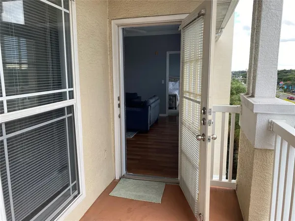 a view of a hallway with wooden floor and entryway
