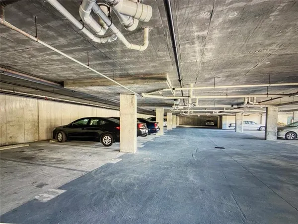 a view of parking garage with cars