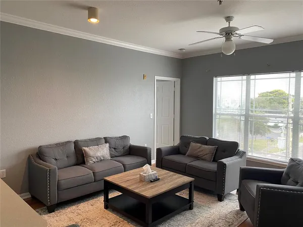 a living room with furniture and a large window