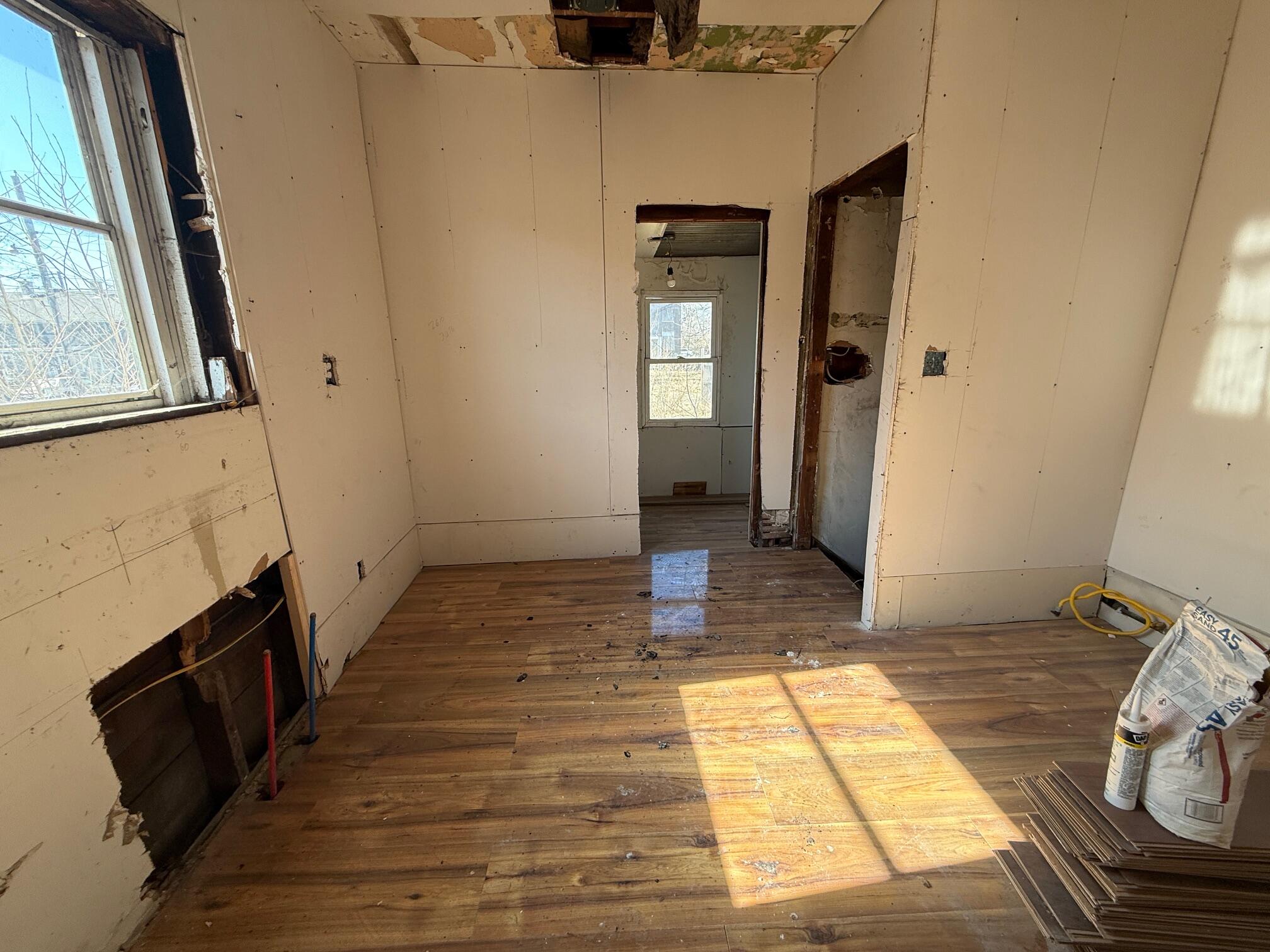 434 Pierce Street Gary, IN 46402 - Photo 4 of 12 a view of a hallway with wooden floor and staircase