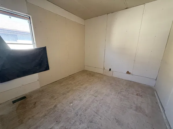 a view of an empty room and window
