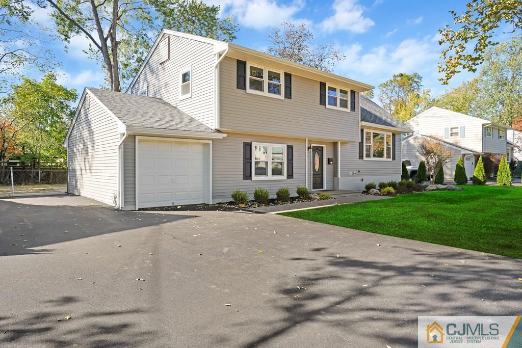 17 Greenbrook Road Middlesex, NJ 08846 - Photo 1 of 24 a front view of a house with a yard and garage