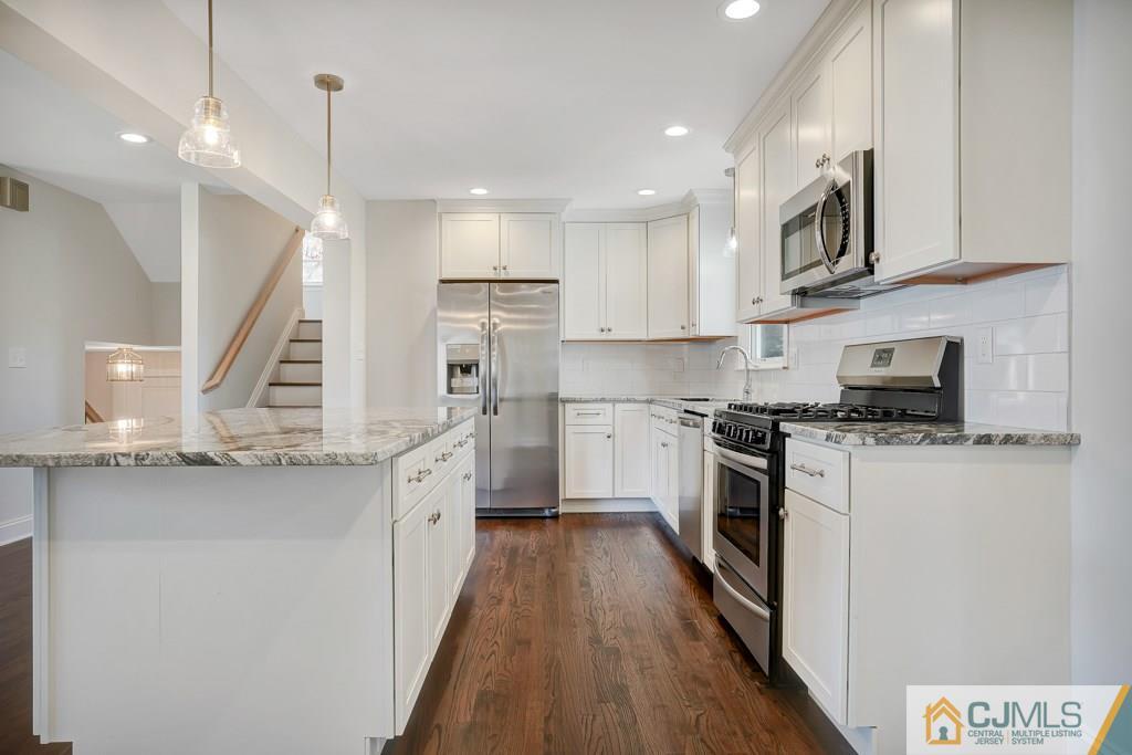 17 Greenbrook Road Middlesex, NJ 08846 - Photo 11 of 24 a kitchen with stainless steel appliances granite countertop a stove a sink and a refrigerator