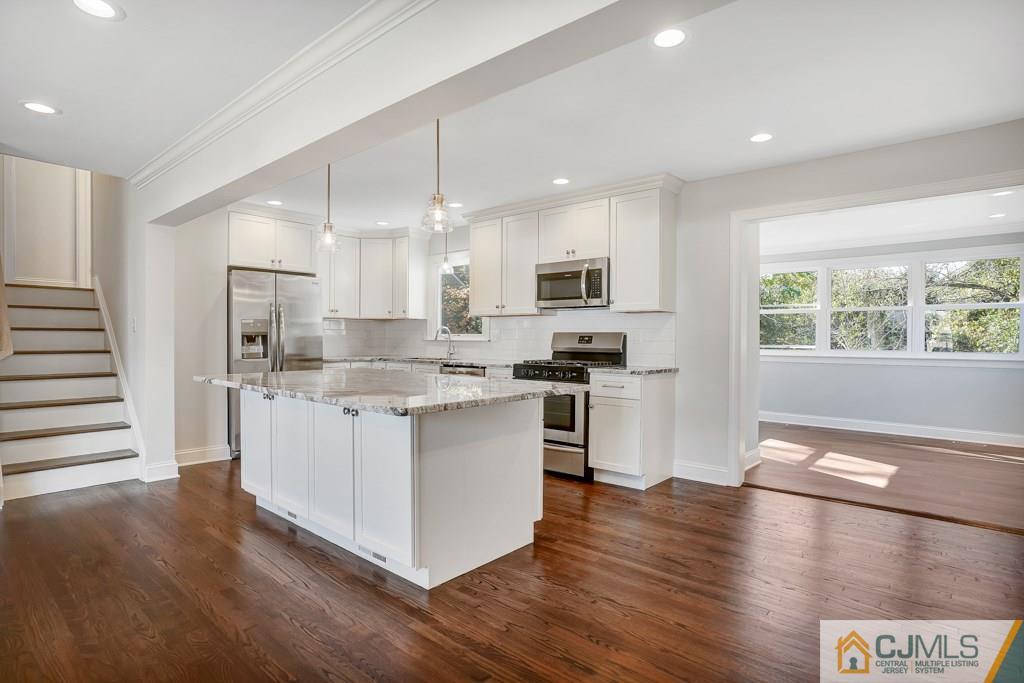 17 Greenbrook Road Middlesex, NJ 08846 - Photo 13 of 24 a kitchen with stainless steel appliances kitchen island granite countertop a stove a sink and a refrigerator