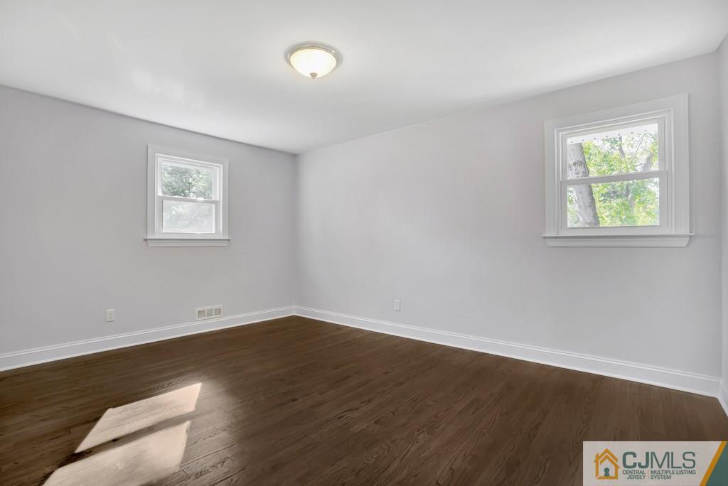 17 Greenbrook Road Middlesex, NJ 08846 - Photo 17 of 24 wooden floor in an empty room with a window