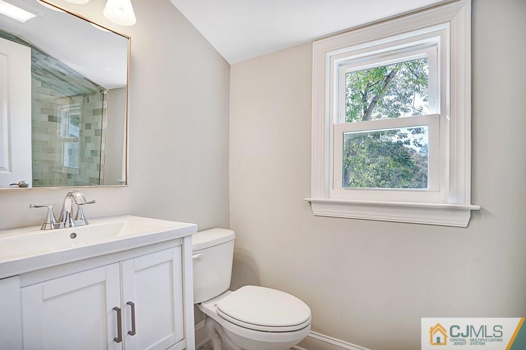 17 Greenbrook Road Middlesex, NJ 08846 - Photo 20 of 24 a bathroom with a toilet a sink a window and a mirror