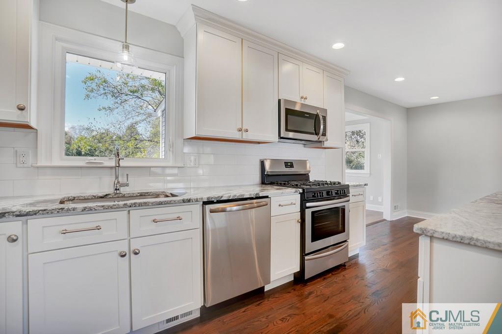 17 Greenbrook Road Middlesex, NJ 08846 - Photo 24 of 24 a kitchen with stainless steel appliances granite countertop a stove a sink and a microwave