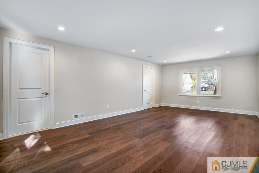 17 Greenbrook Road Middlesex, NJ 08846 - Photo 4 of 24 a view of an empty room with wooden floor and a window