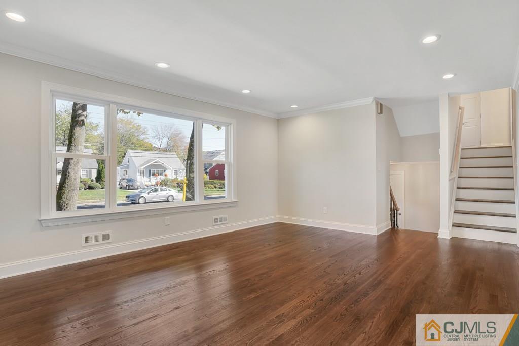 17 Greenbrook Road Middlesex, NJ 08846 - Photo 7 of 24 a view of an empty room with wooden floor and a window