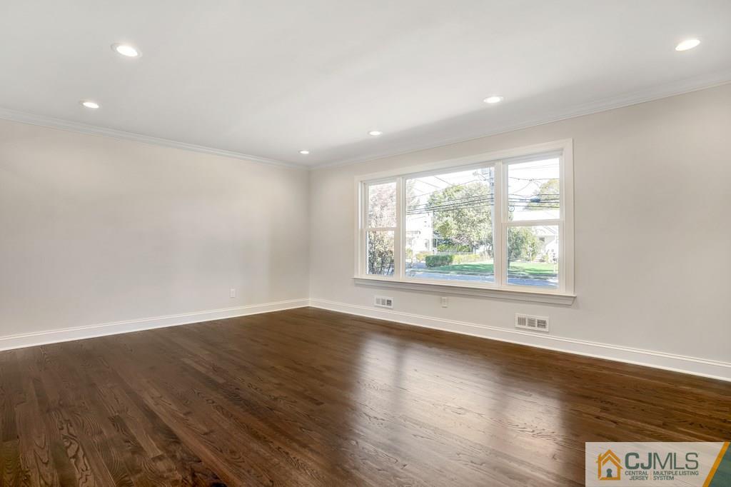 17 Greenbrook Road Middlesex, NJ 08846 - Photo 8 of 24 an empty room with wooden floor and windows