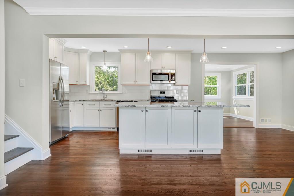 17 Greenbrook Road Middlesex, NJ 08846 - Photo 10 of 24 a kitchen with kitchen island white cabinets and stainless steel appliances