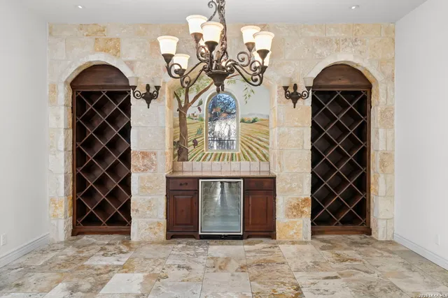 a view of a dining room with furniture and chandelier