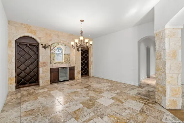 a view of a big room with wooden floor and windows