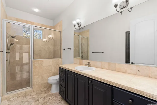 an empty room with wooden floor and ceiling fan
