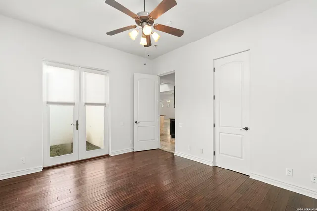 a kitchen with granite countertop white cabinets and a sink