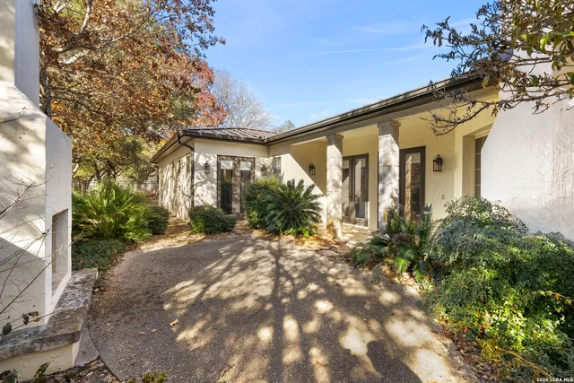 a living room with furniture a fire pit and a tree