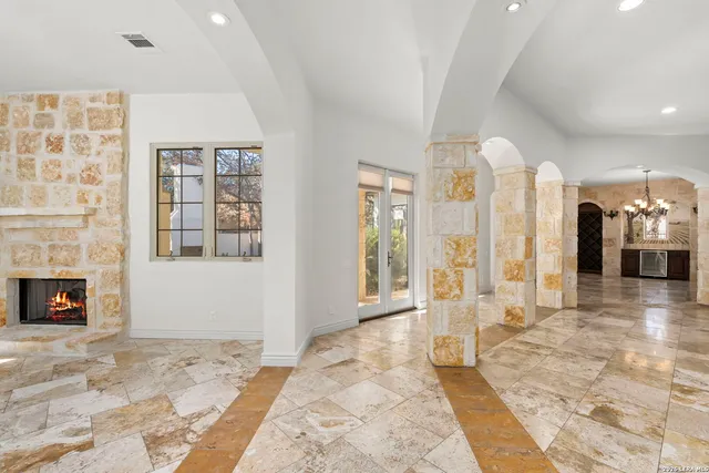 a view of a livingroom with wooden floor and a fireplace
